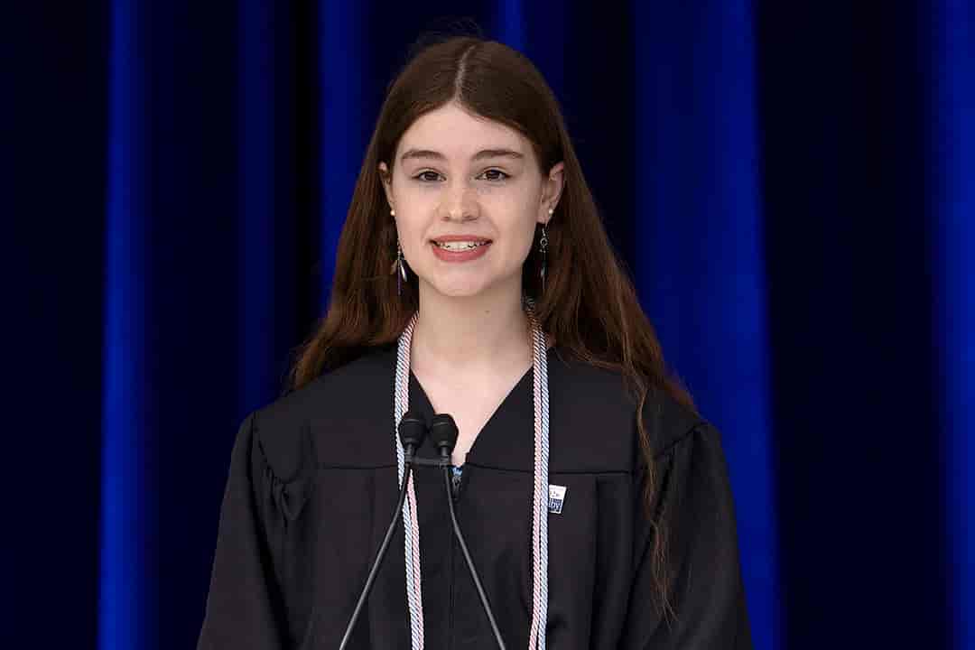 Female college graduate speaking during graduation ceremony