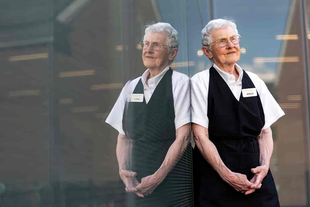 Portrait of a older woman dressed in her food service uniform