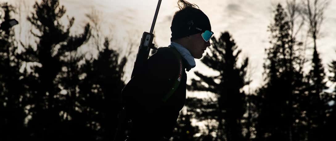 Close up of biathlon rifle being fired with casing flying out of rifle