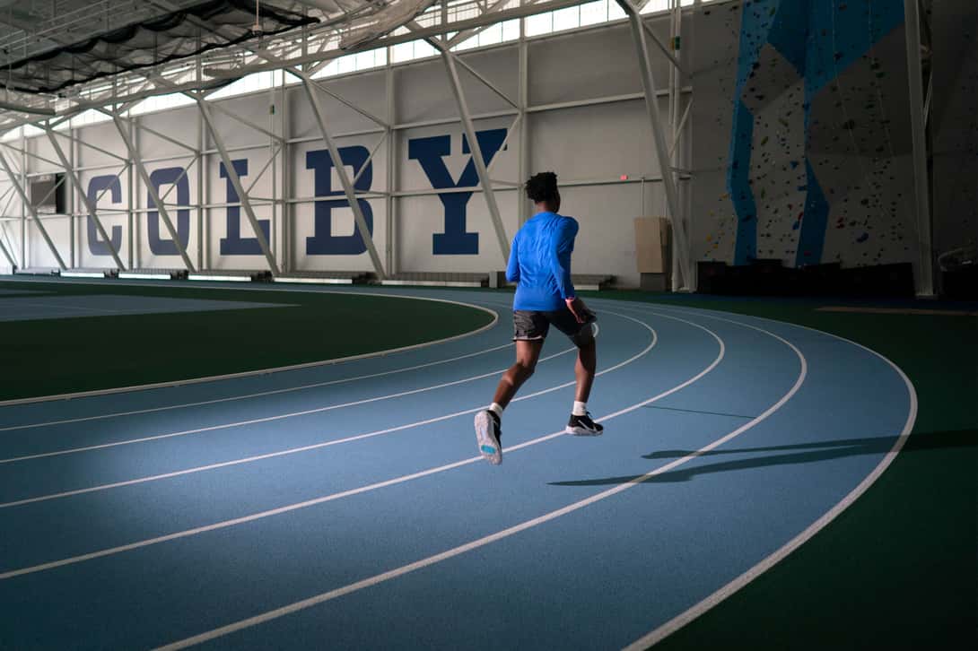 Harold Alfond Athletic Center Field House with runner