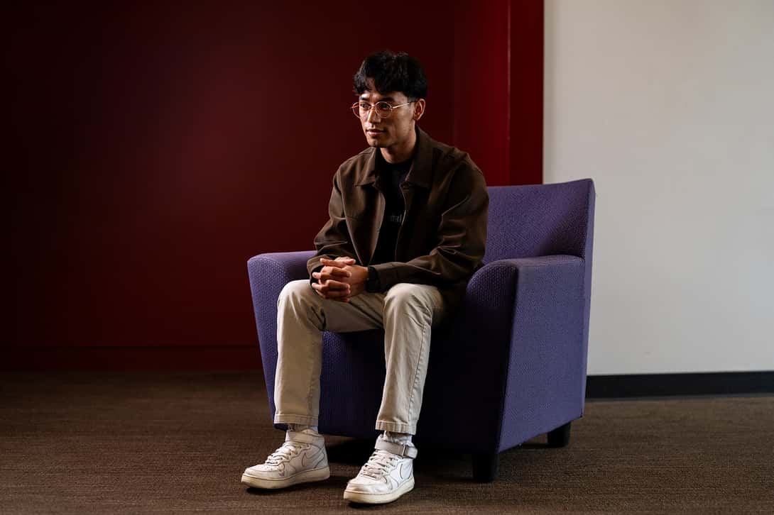 Portrait of a male college student sitting in a chair
