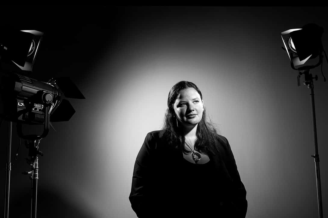 Female college student sitting for a portrait in a photo studio