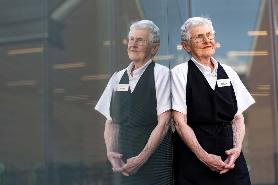 Portrait of a older woman dressed in her food service uniform
