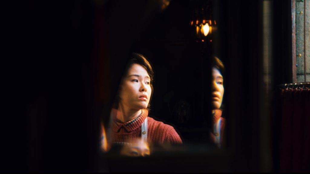 A person poses for a photo while looking to the right.
