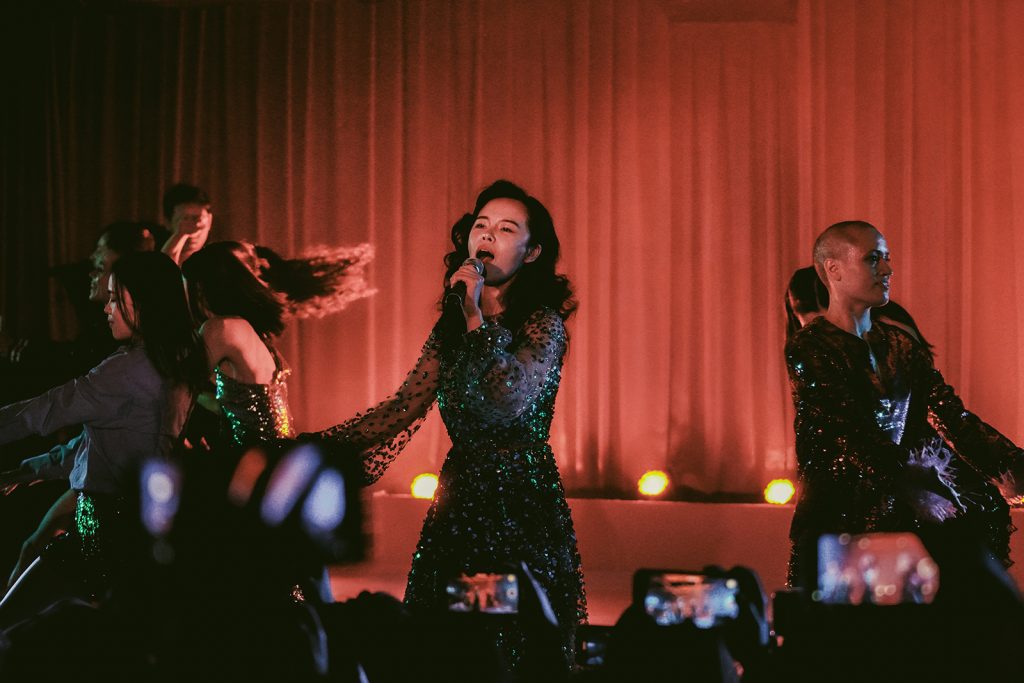 A singer on stage holding a microphone.