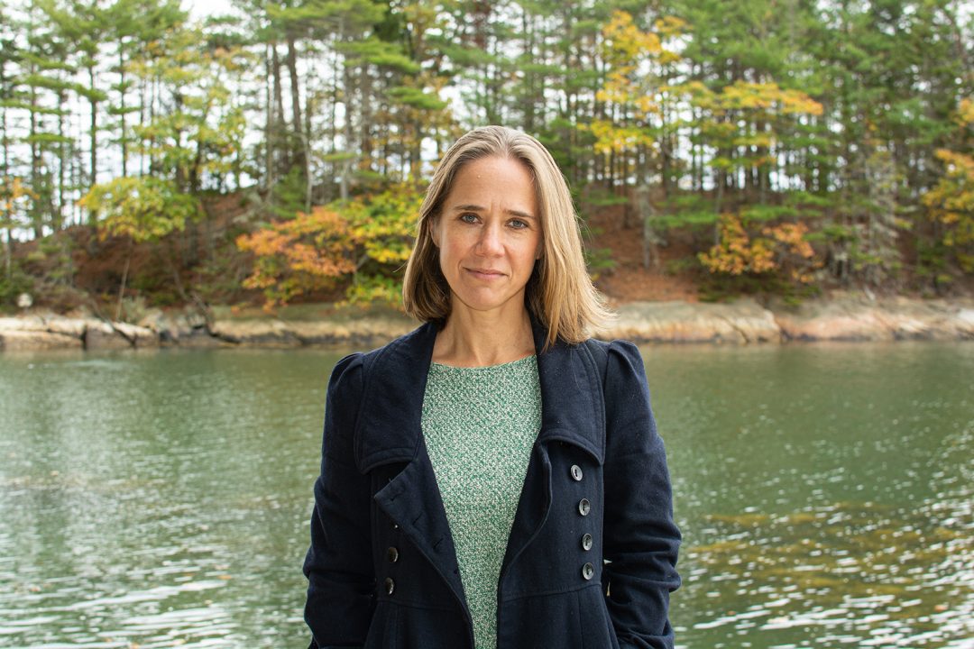 Portrait of a female professor in front of a body of water