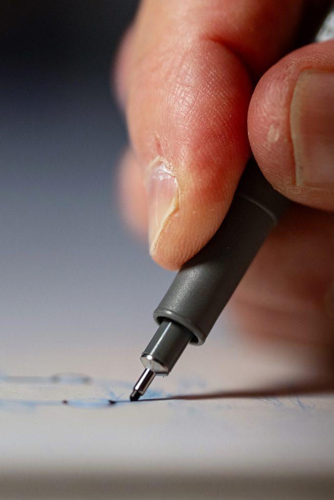 A pen tip touching paper.