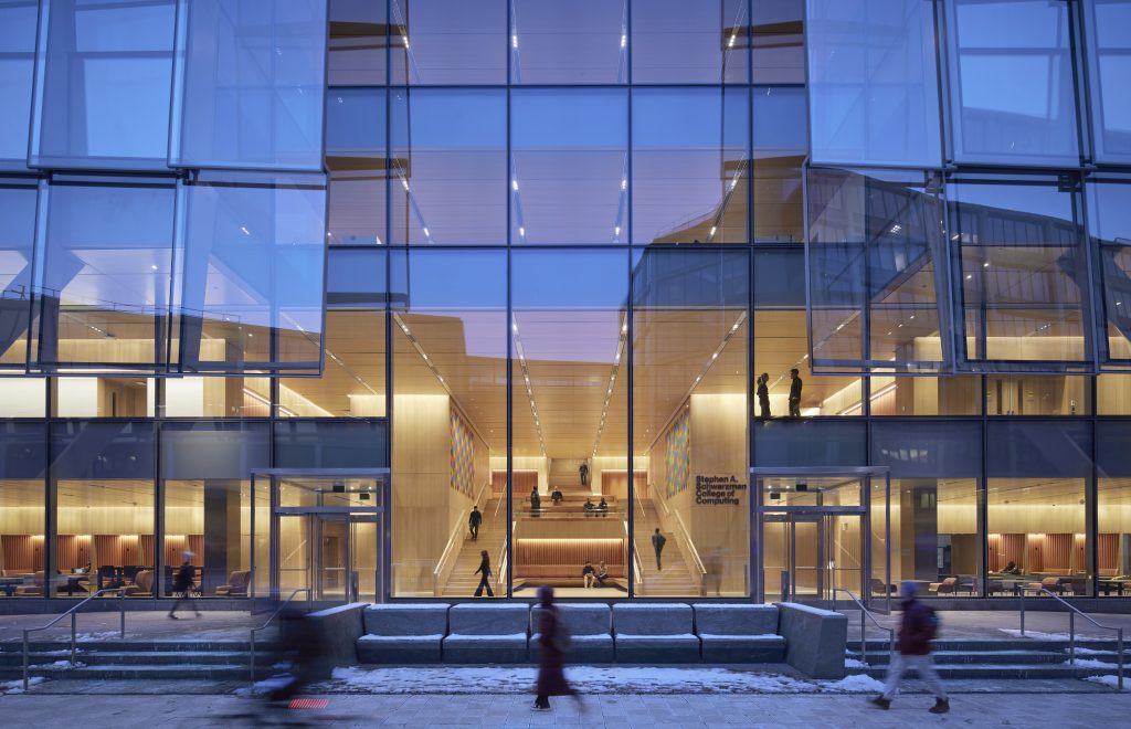 Large glass planes of the front of a modern building.