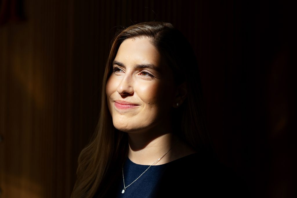 A woman looking left posed for a photo.