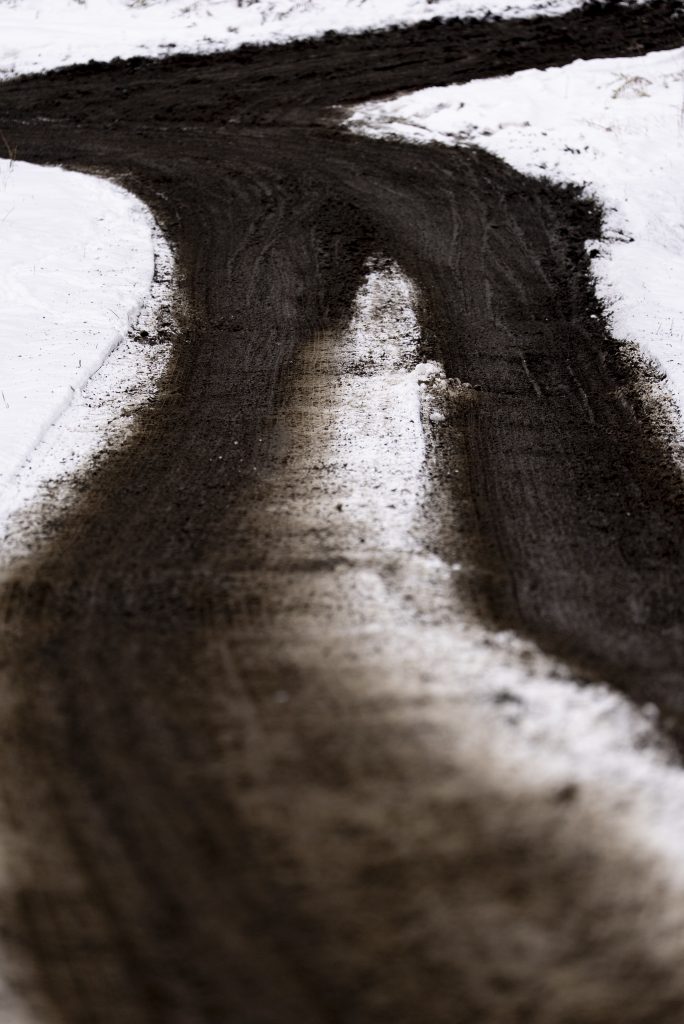 Muddy tracks through fresh snow.