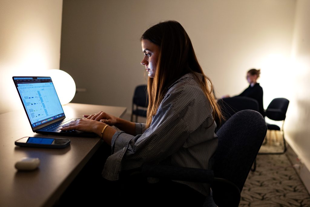 A student works at a computer. 
