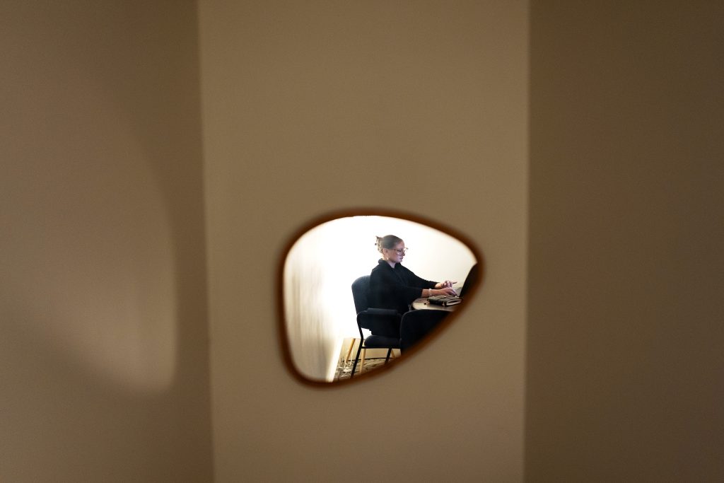 A person is reflected in a mirror. 