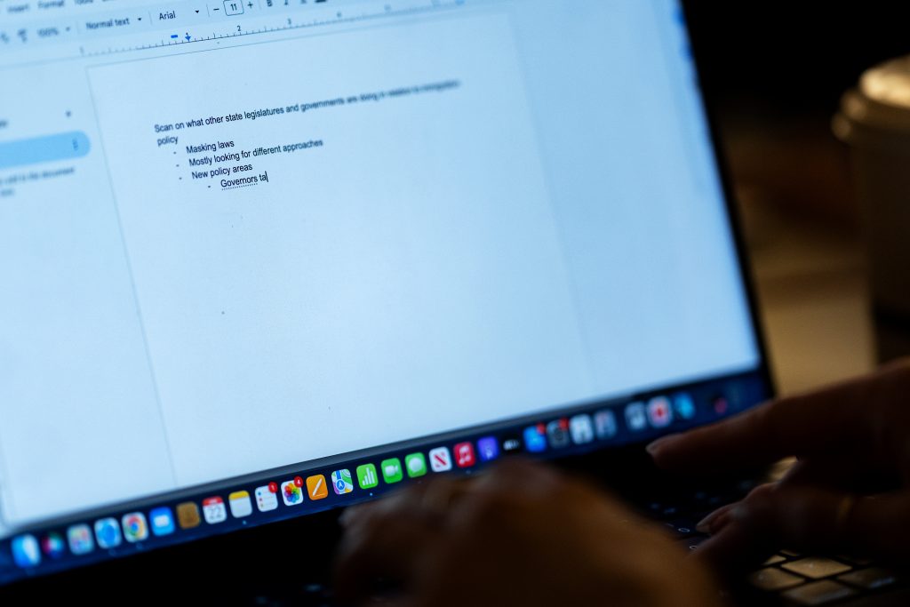 A student takes notes on a computer. 