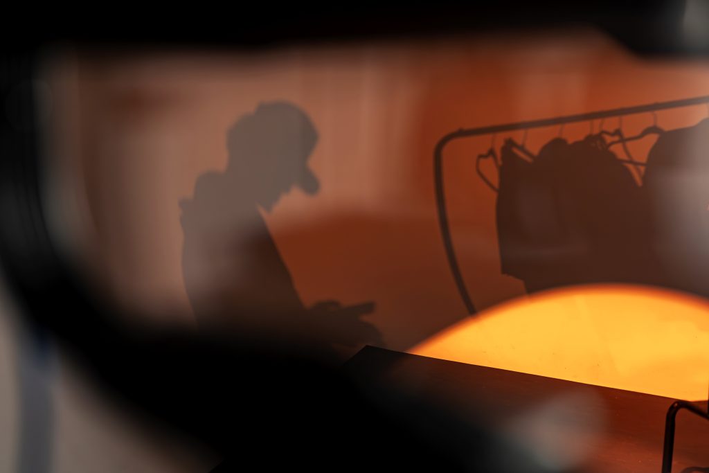 A figure is silhouetted against the light. 
