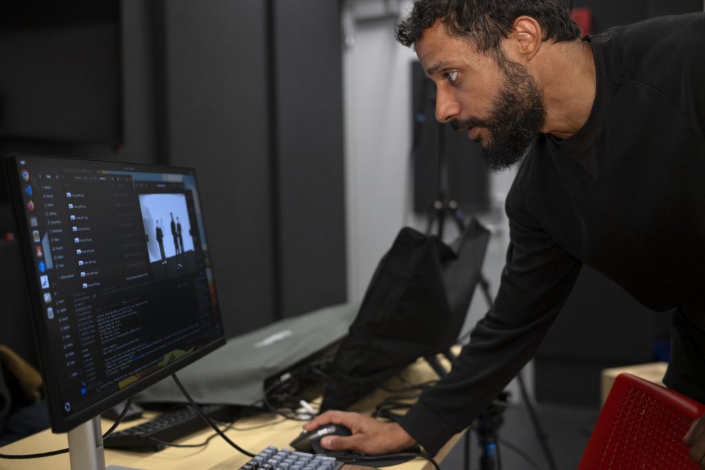 A professor works at a computer. 