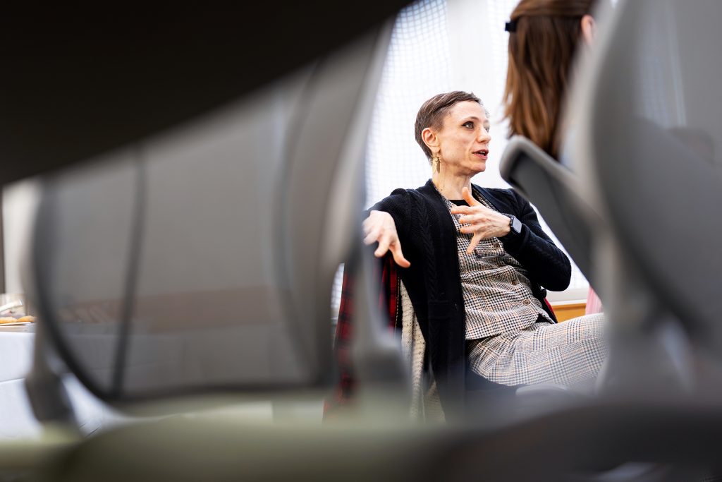 A photo of a seated person making a point. 