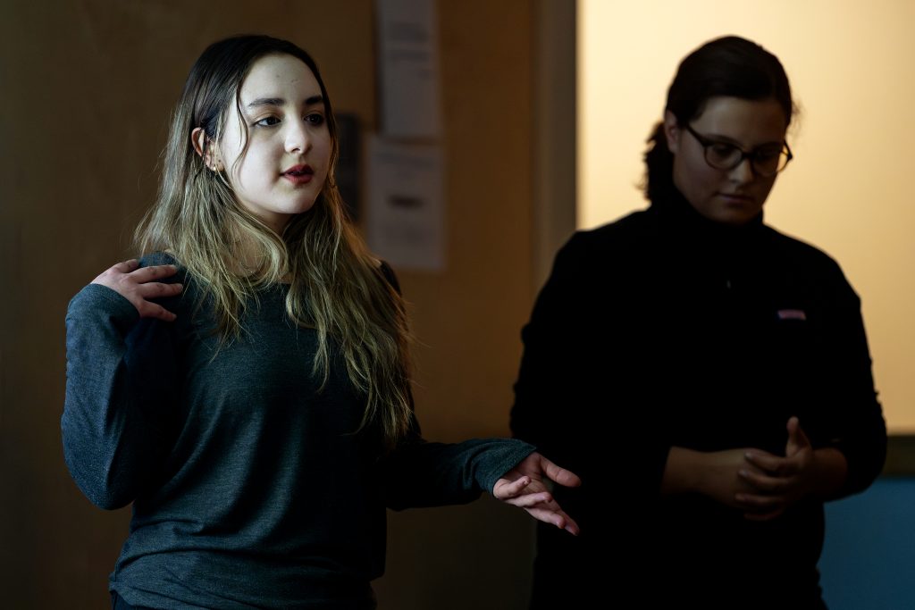 A student helps lead a workshop.