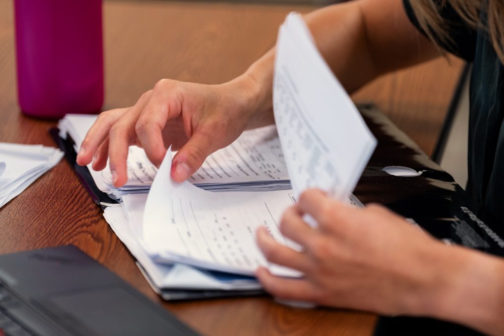 Hands flip through papers
