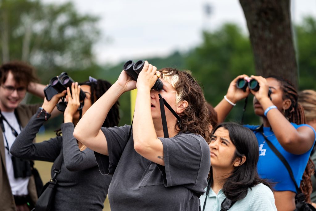 A group of people look for birds