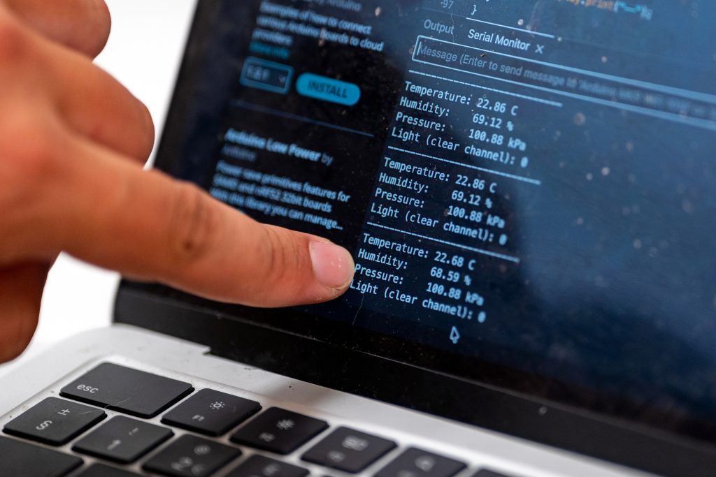 A person points at a computer screen. 