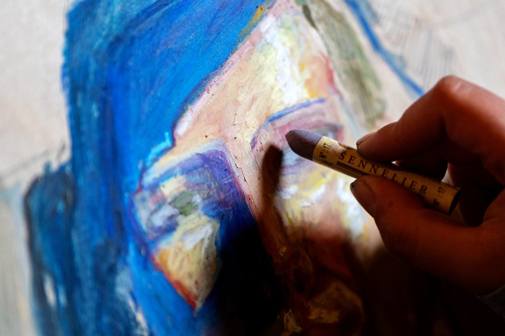 A person works on a painting. 