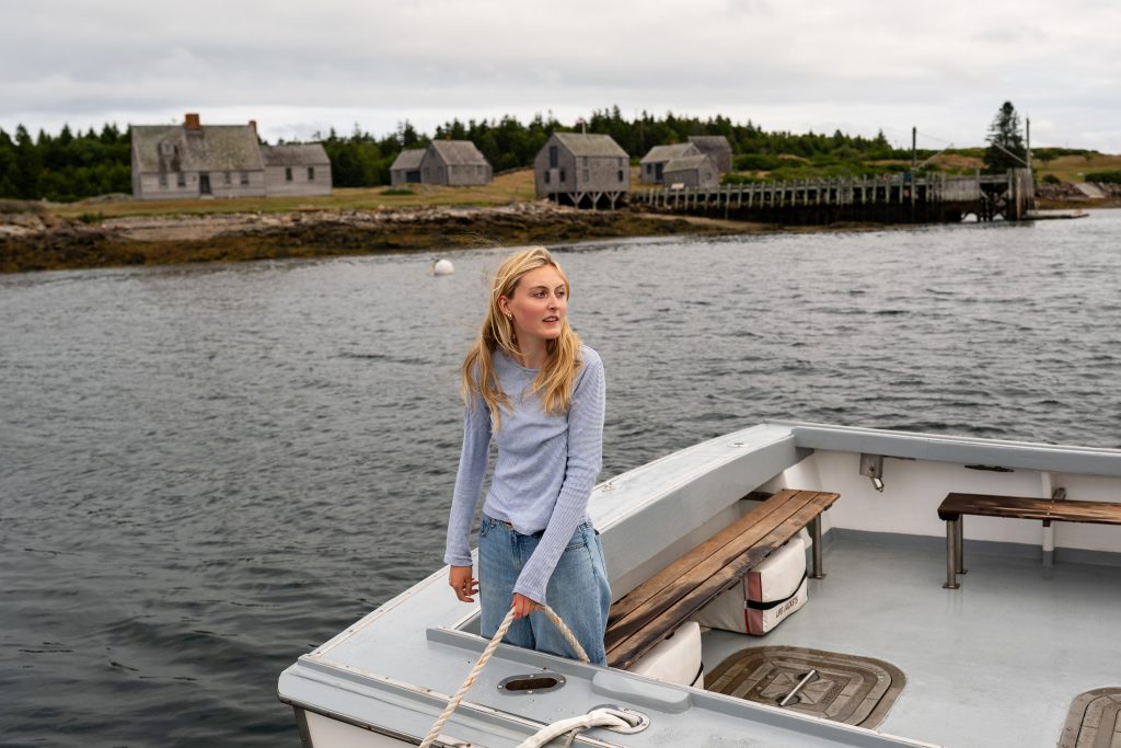 A person holds a line on a boat. 