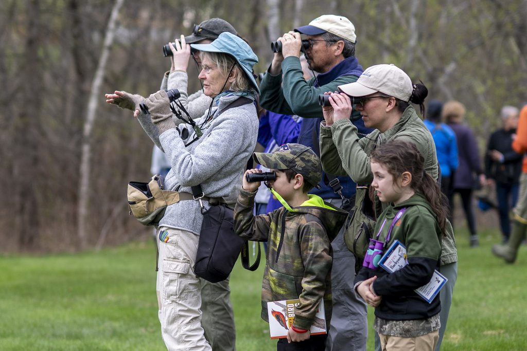 Community members look for birds on campus. 