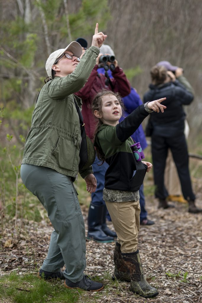 Community members look for birds on campus. 