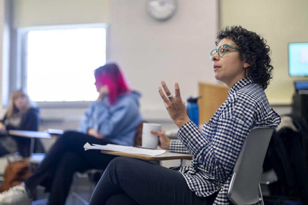 A professor works with students. 