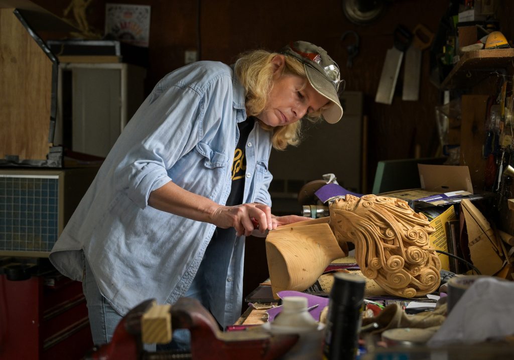 Wood carver in her studio