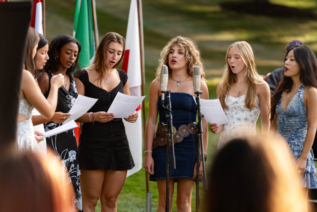 A group of students sing. 