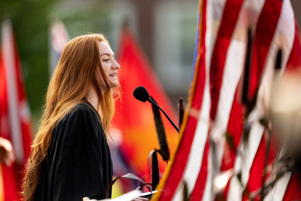 A student delivers remarks at a ceremonial event. 