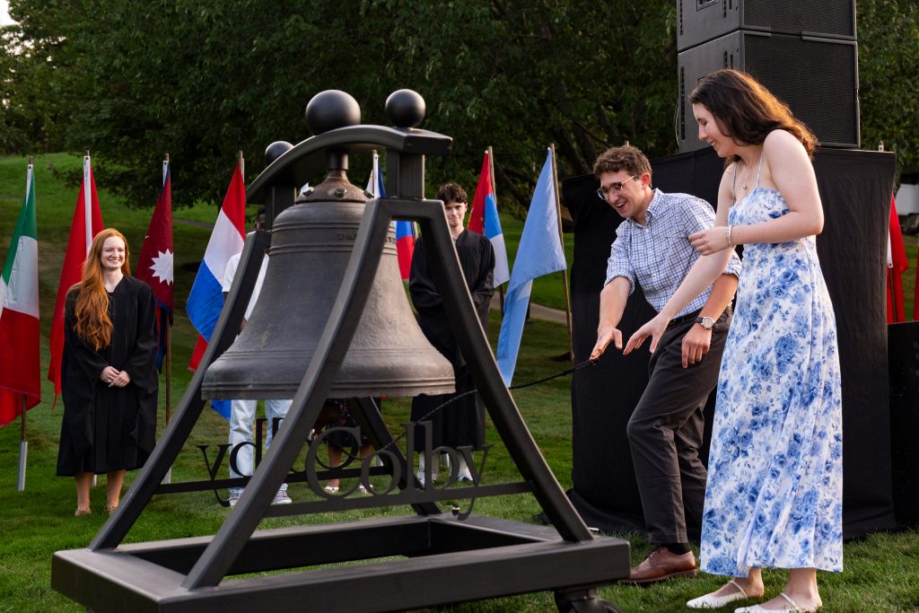 Two students strike the Revere Bell. 