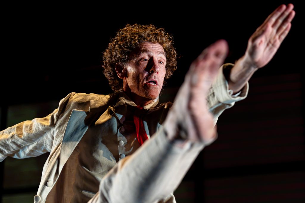 One man dances on a stage. 