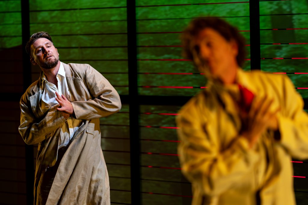 Two men dance on a stage. 